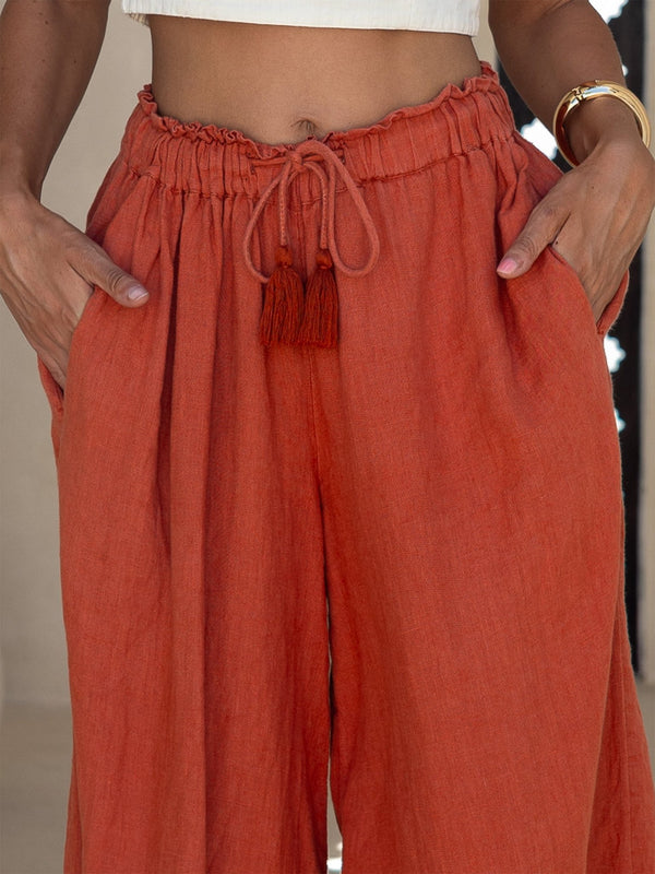 Person wearing orange pants with a blurred background
