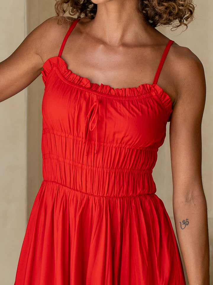 Red dress worn by a person with a neutral background