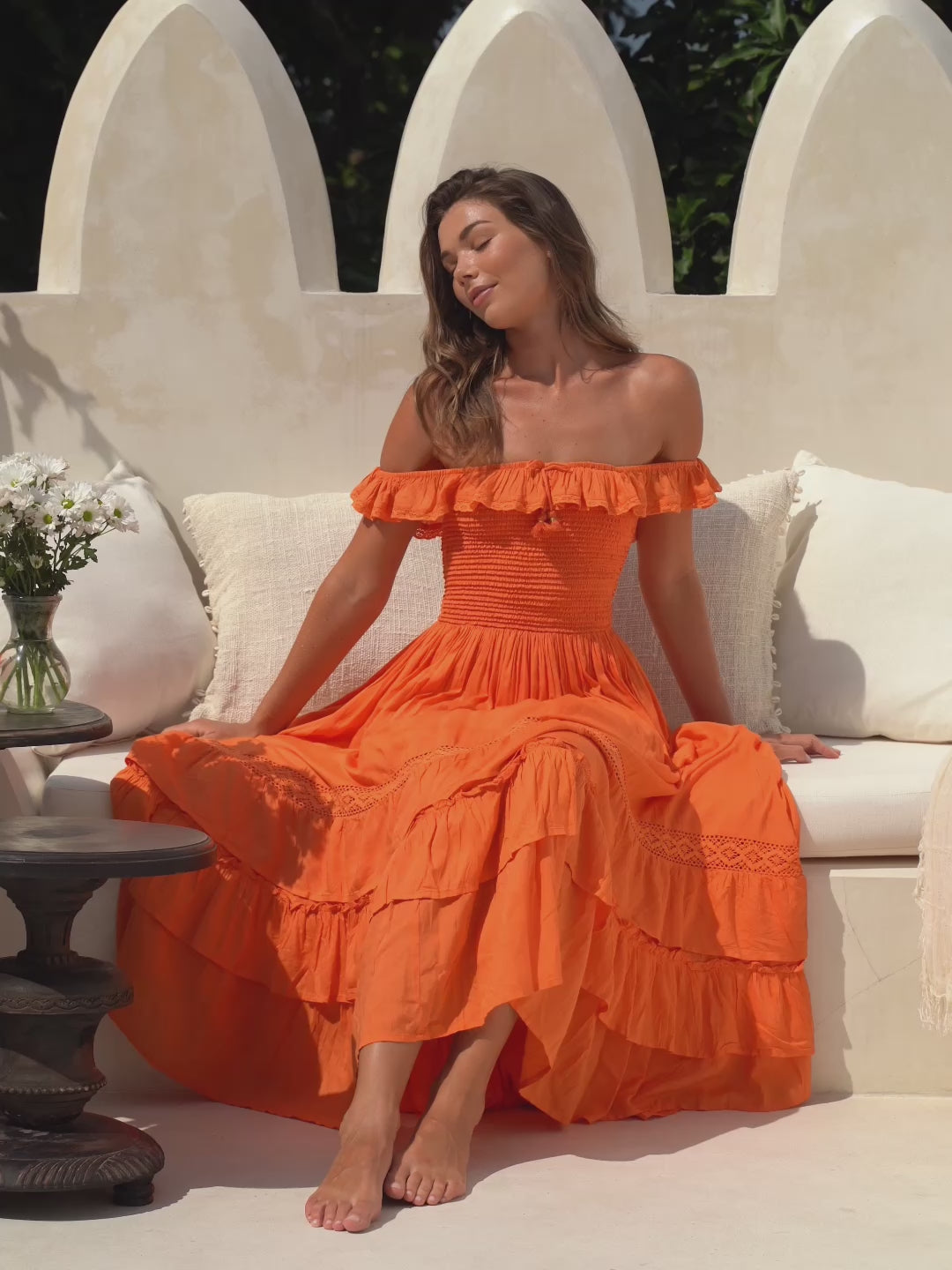 women wearing a orange maxi dress from cocopiña boho-chic dresses